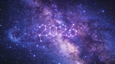Deep space galaxy image with glowing 2026 numerals formed like a constellation among stars and nebula colors.
