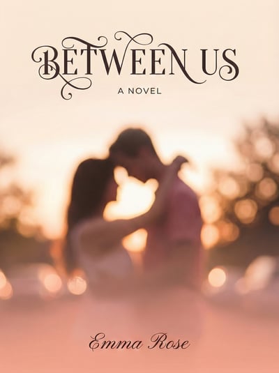 Romance book cover titled Between Us with soft-focus couple silhouette and warm sunset bokeh.