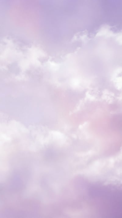 Vertical pastel phone wallpaper with fluffy white clouds and lavender-pink dreamy sky tones.