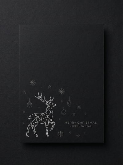 Black minimalist Christmas greeting card with a geometric white reindeer line drawing, small snowflakes, and elegant holiday text.